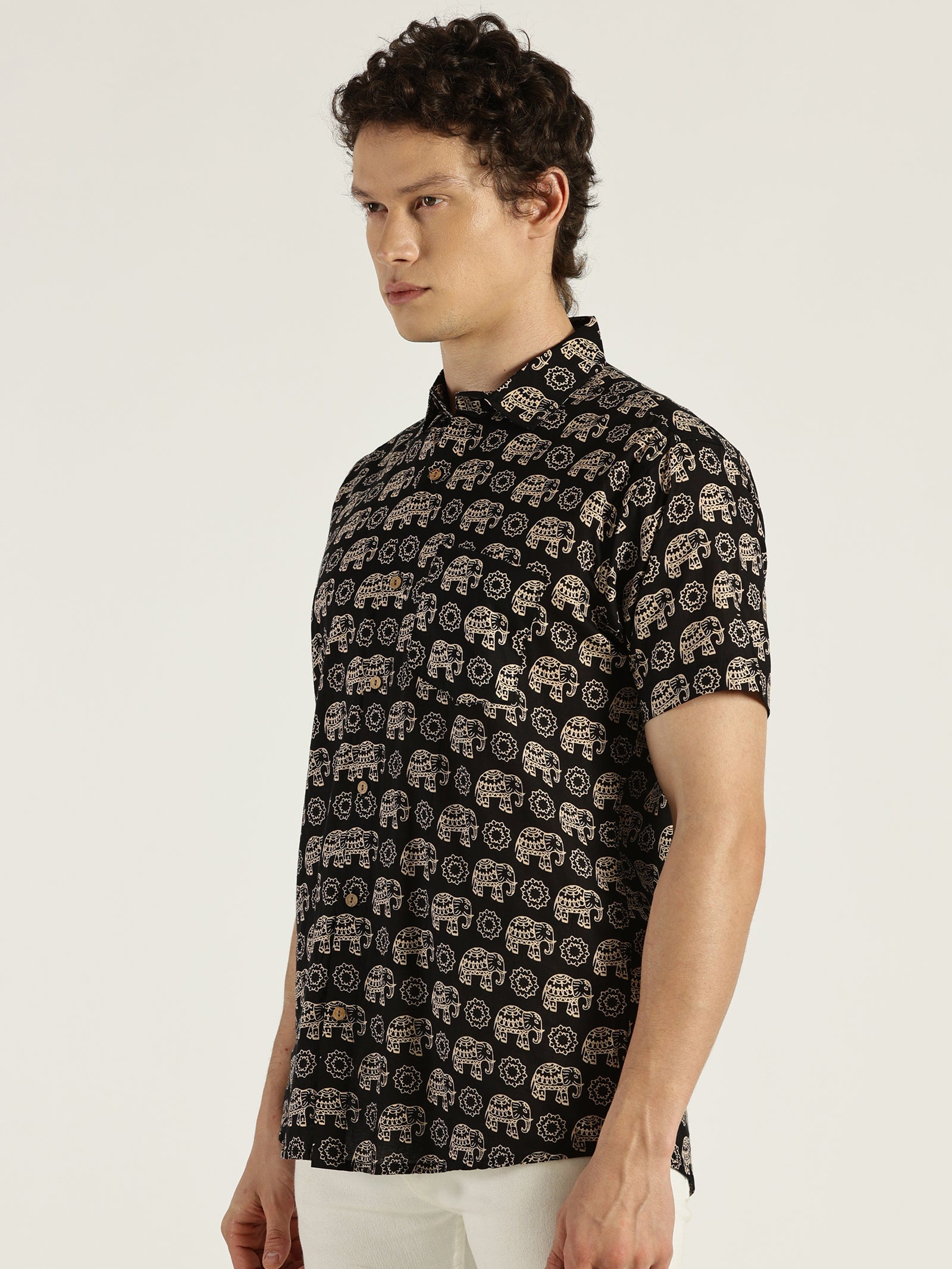 Model Looking sideways wearing Black Ethnic Elephant Printed Halfsleeves Cotton Shirt by Brand Patrah