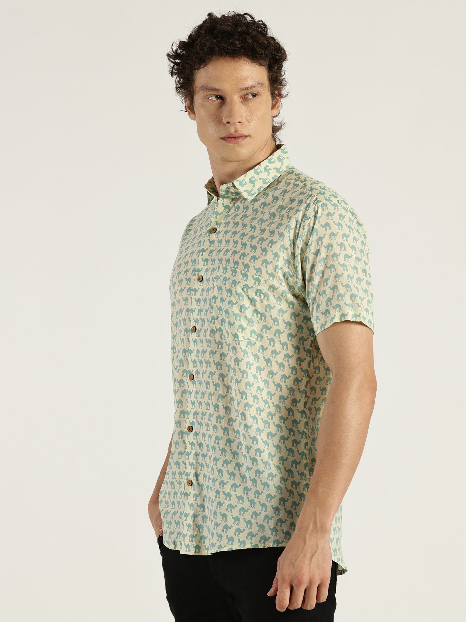 Model Looking sideways wearing Light Blue Camel Printed Halfsleeves Cotton Shirt by Brand Patrah