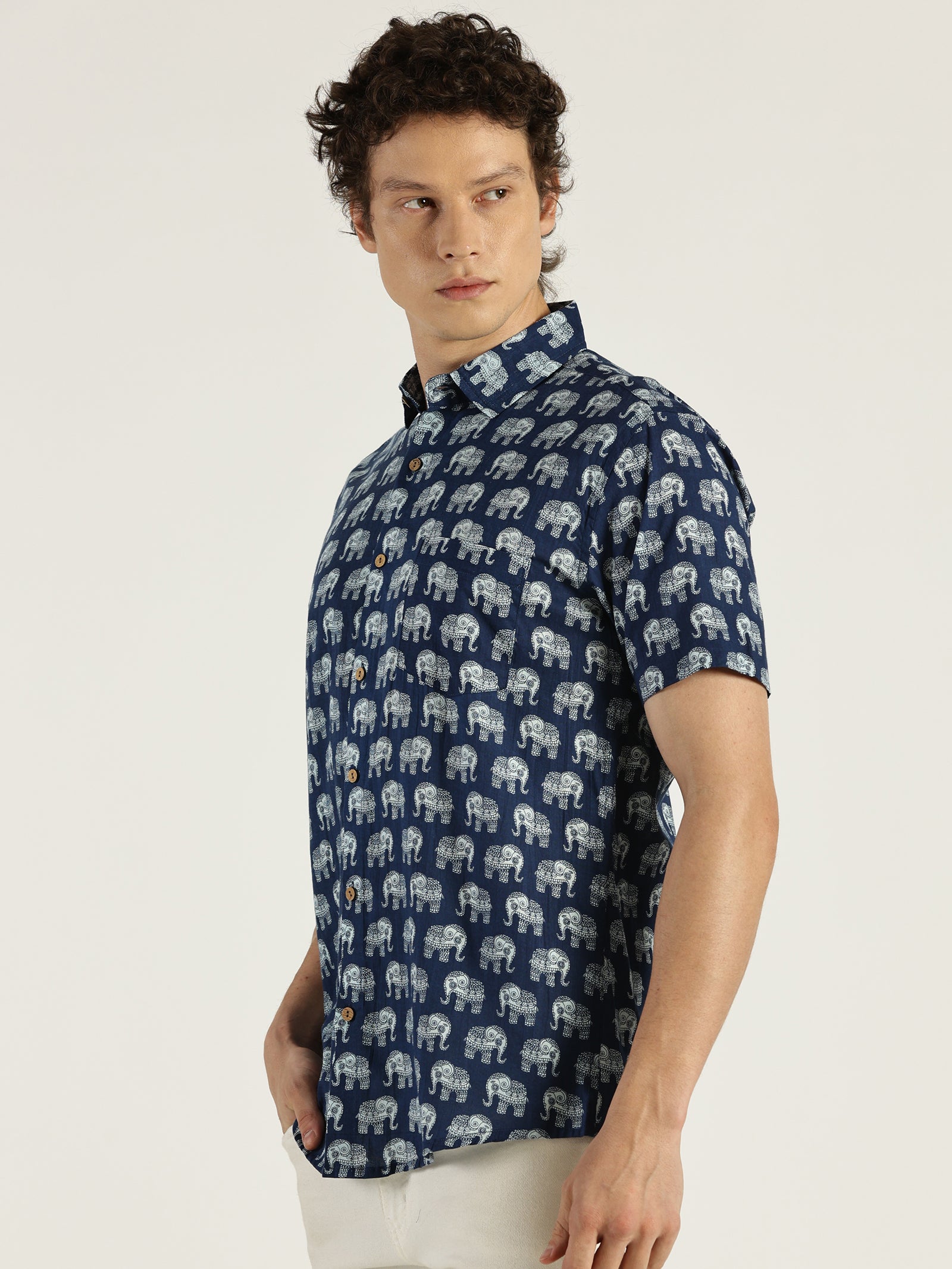 Model Facing sideways wearing Indigo Ethnic Elephant Printed Halfsleeves Cotton Shirt by Brand Patrah