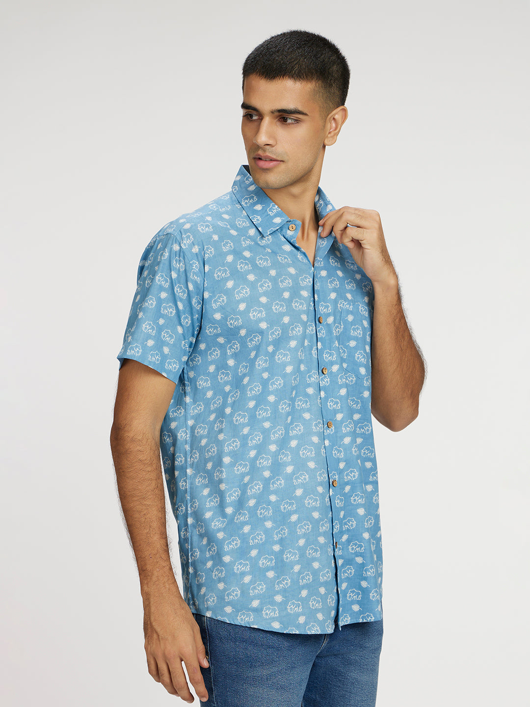 Model Facing sideways wearing Blue skies white elephant printed Halfsleeves Cotton Shirt by Brand Patrah