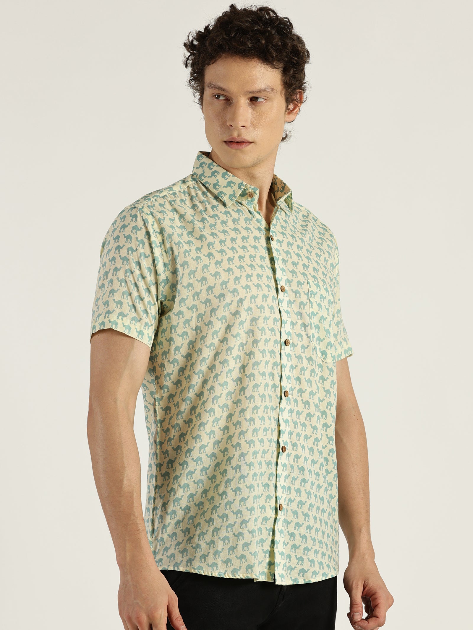 Model Looking sideways wearing Light Blue Camel Printed Halfsleeves Cotton Shirt by Brand Patrah
