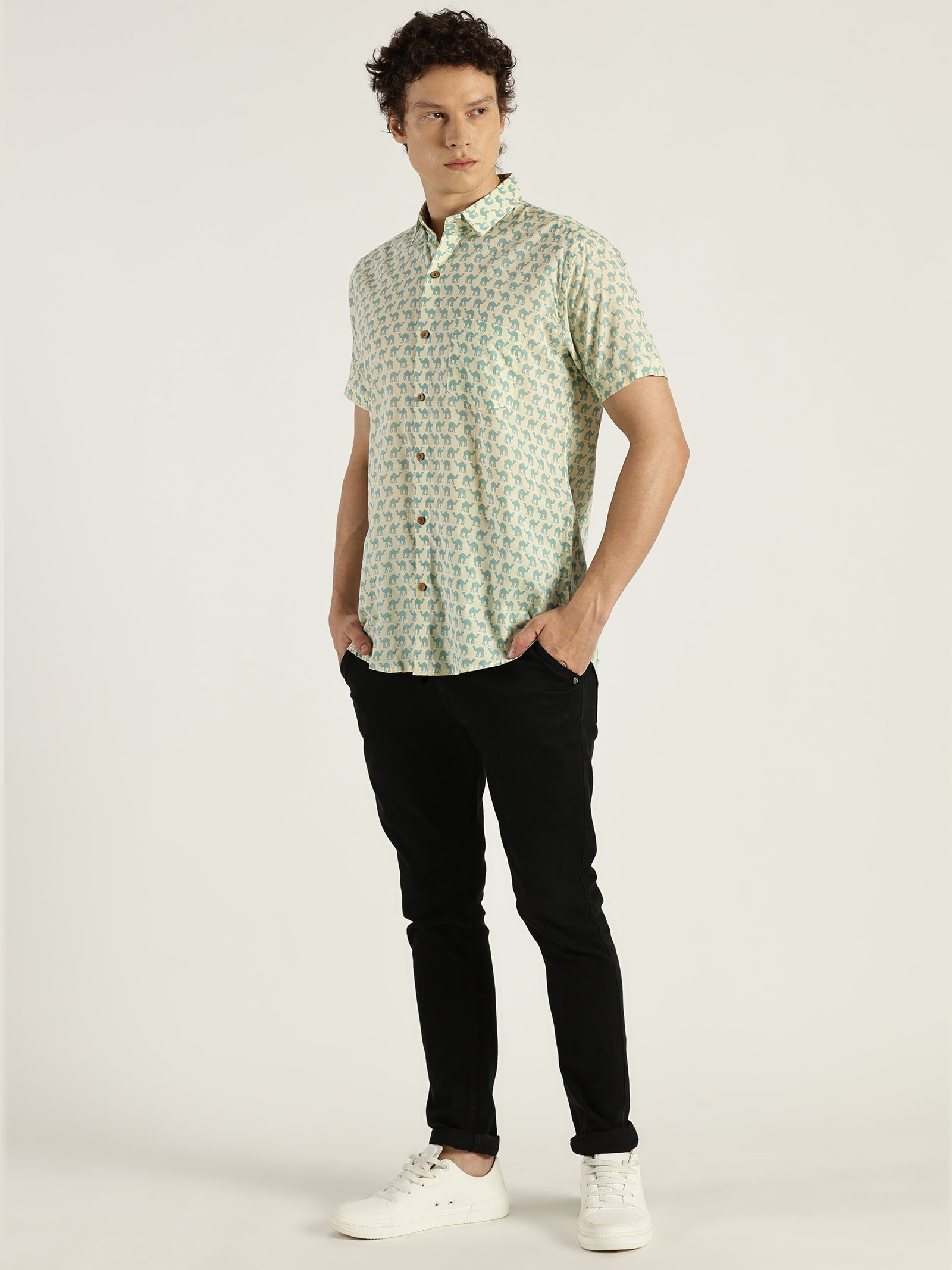 Model Looking sideways wearing Light Blue Camel Printed Halfsleeves Cotton Shirt by Brand Patrah