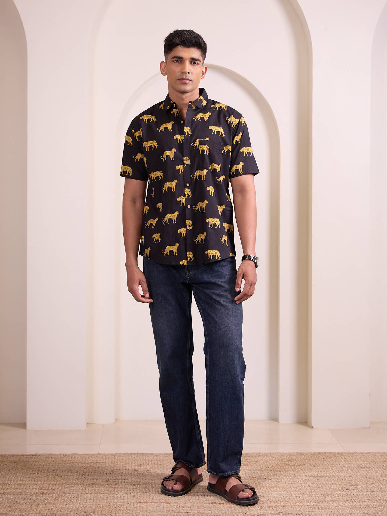 Full body view of men’s cheetah print shirt styled for casual vacation