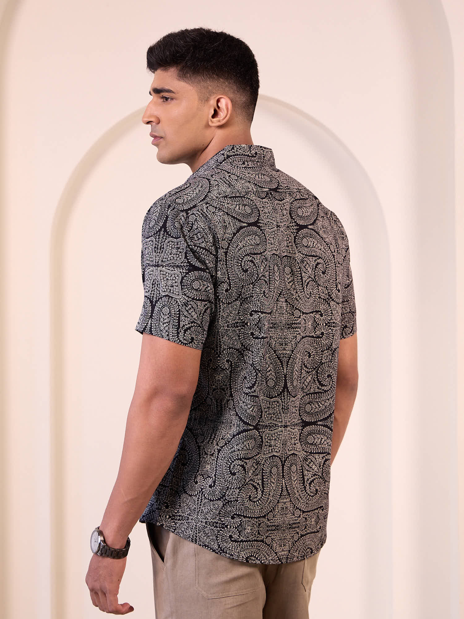 Model wearing printed short sleeve shirt back design