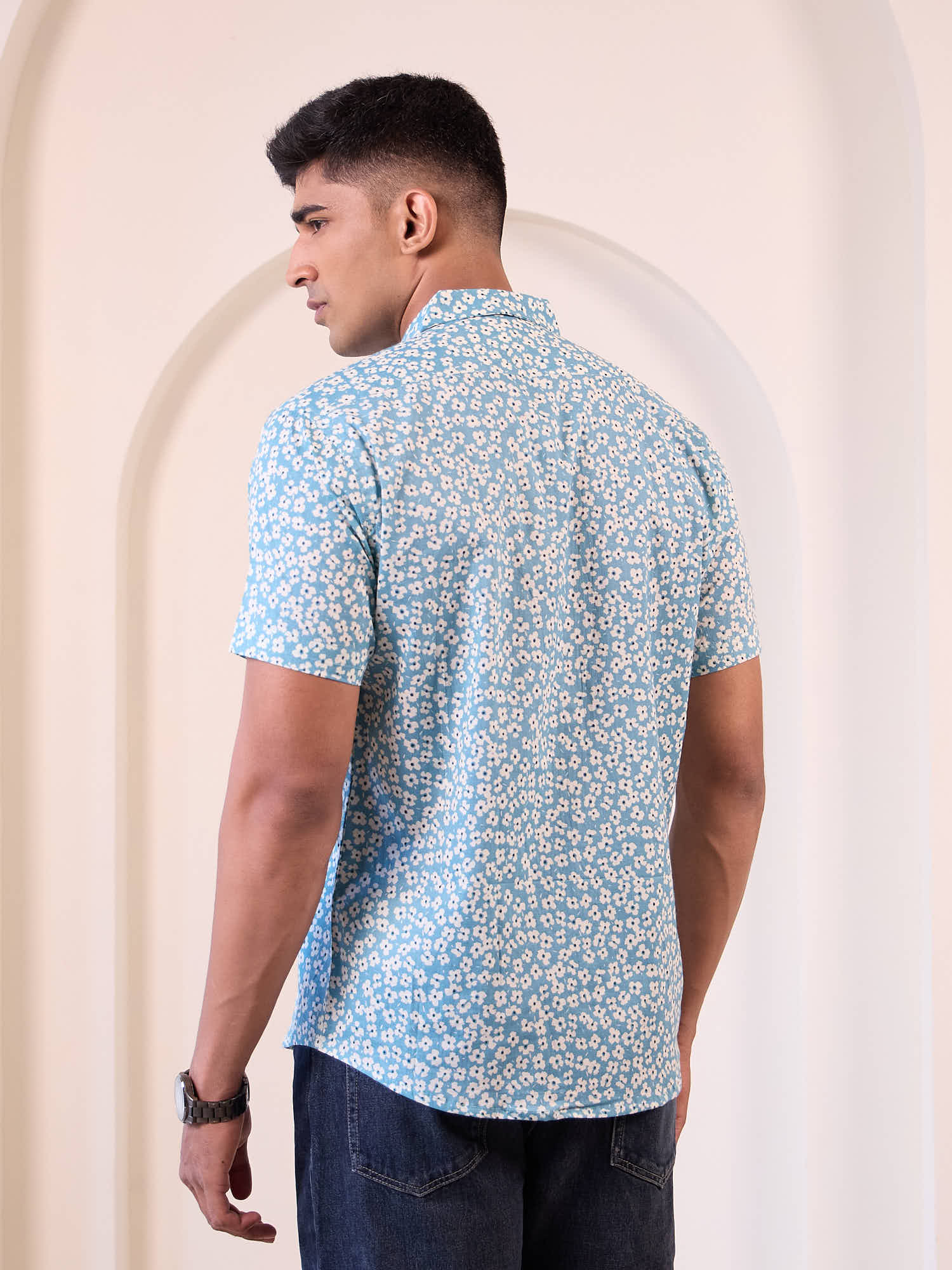 Model wearing printed short sleeve shirt back design