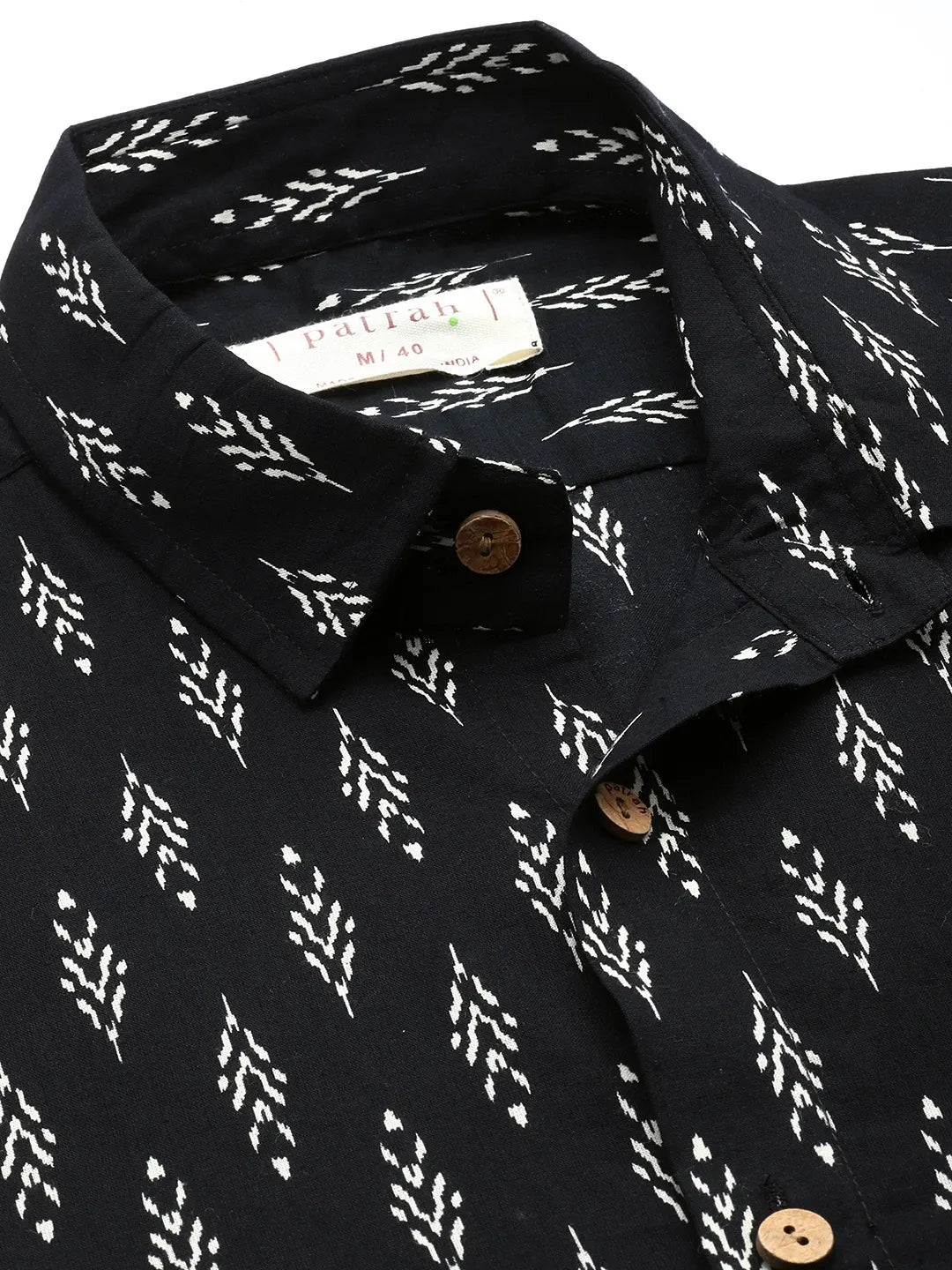 Close-up of black ikkat cotton shirt fabric showing detailed print
