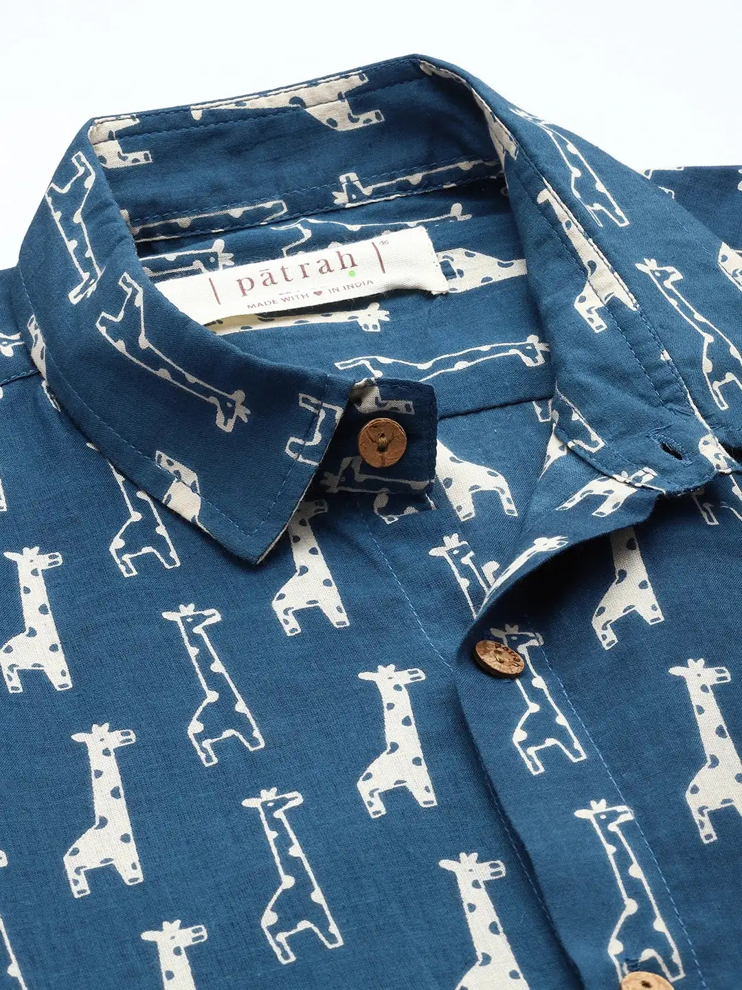 Close-up of blue cotton shirt with giraffe print detailing