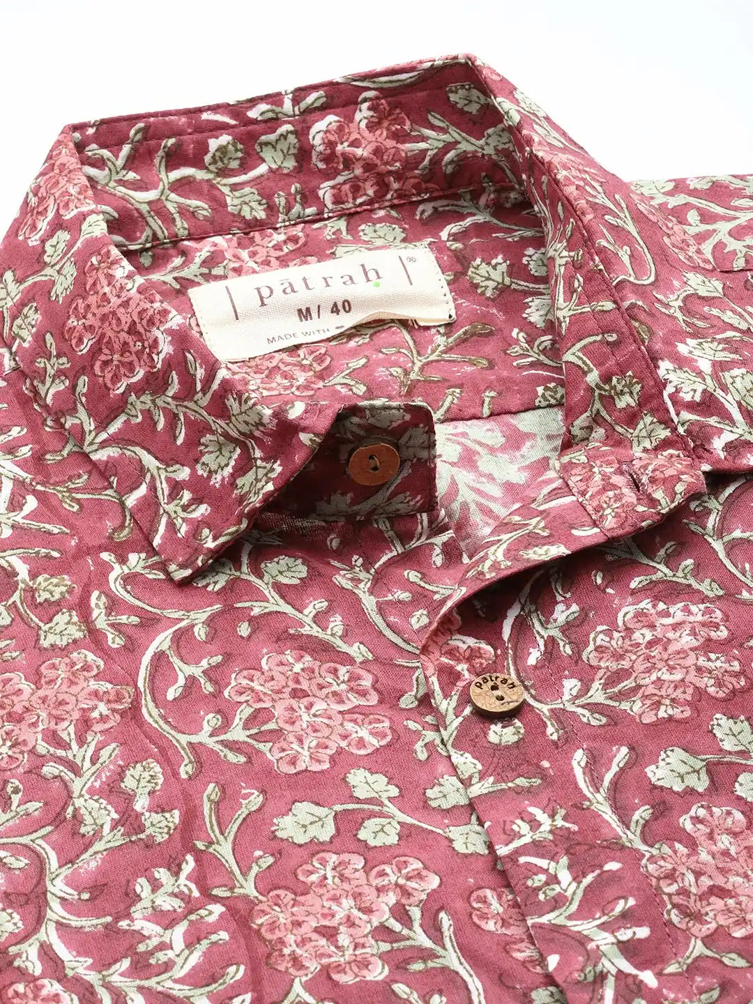 Close-up of rouge cotton shirt showing bold floral print