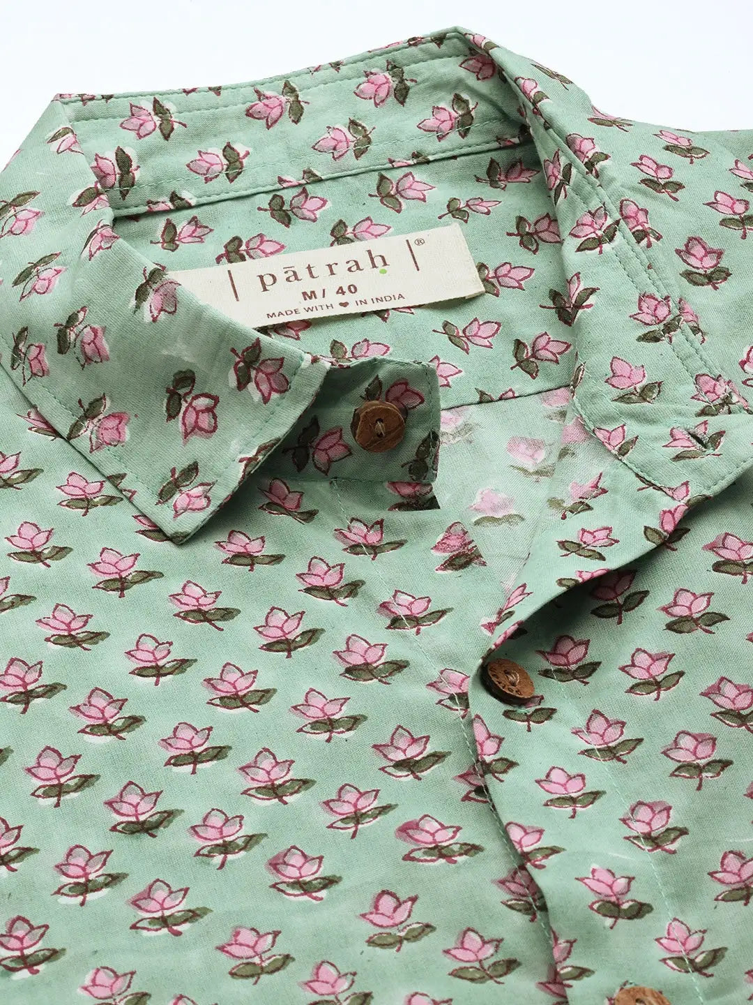 Close-up of sage green floral cotton fabric showing texture