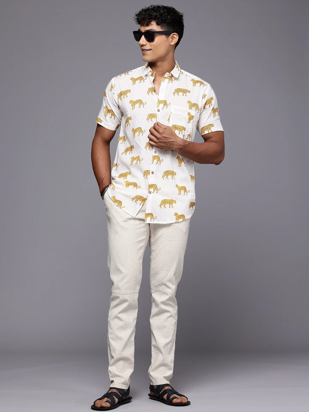Full body view of men’s cheetah print shirt styled for casual vacation