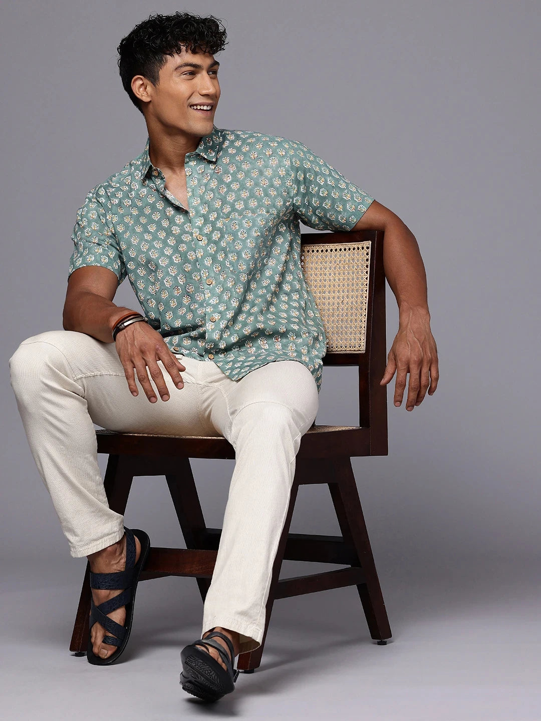 Full body view of olive floral print shirt styled for relaxed Sunday