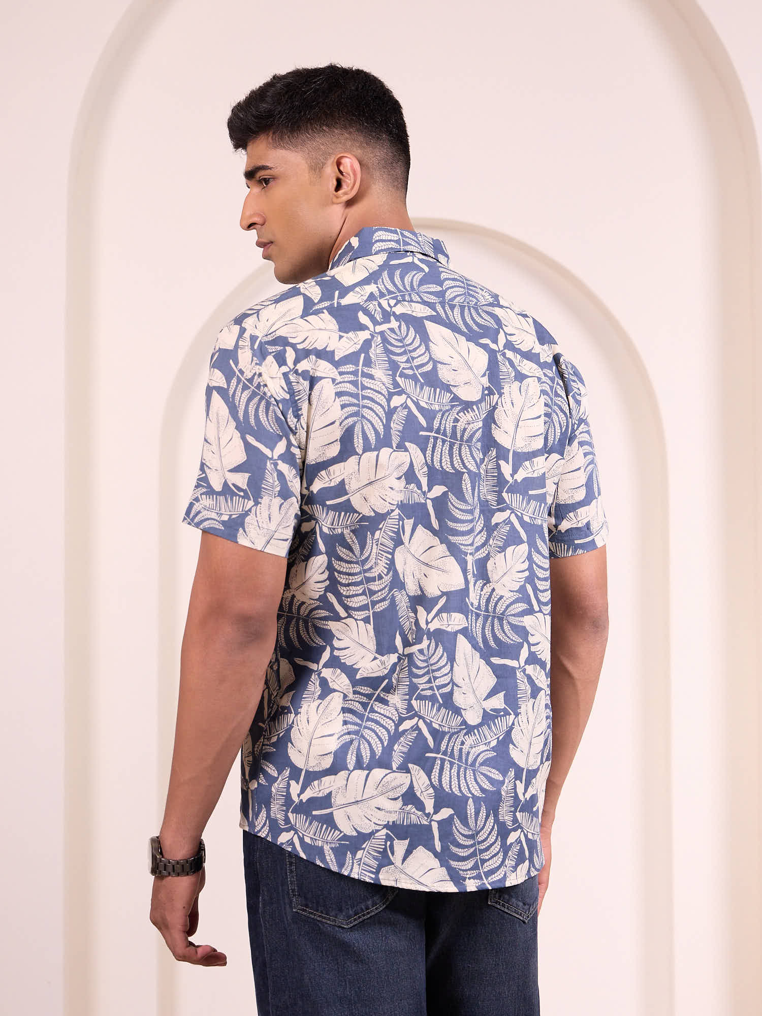 Model wearing printed short sleeve shirt back design