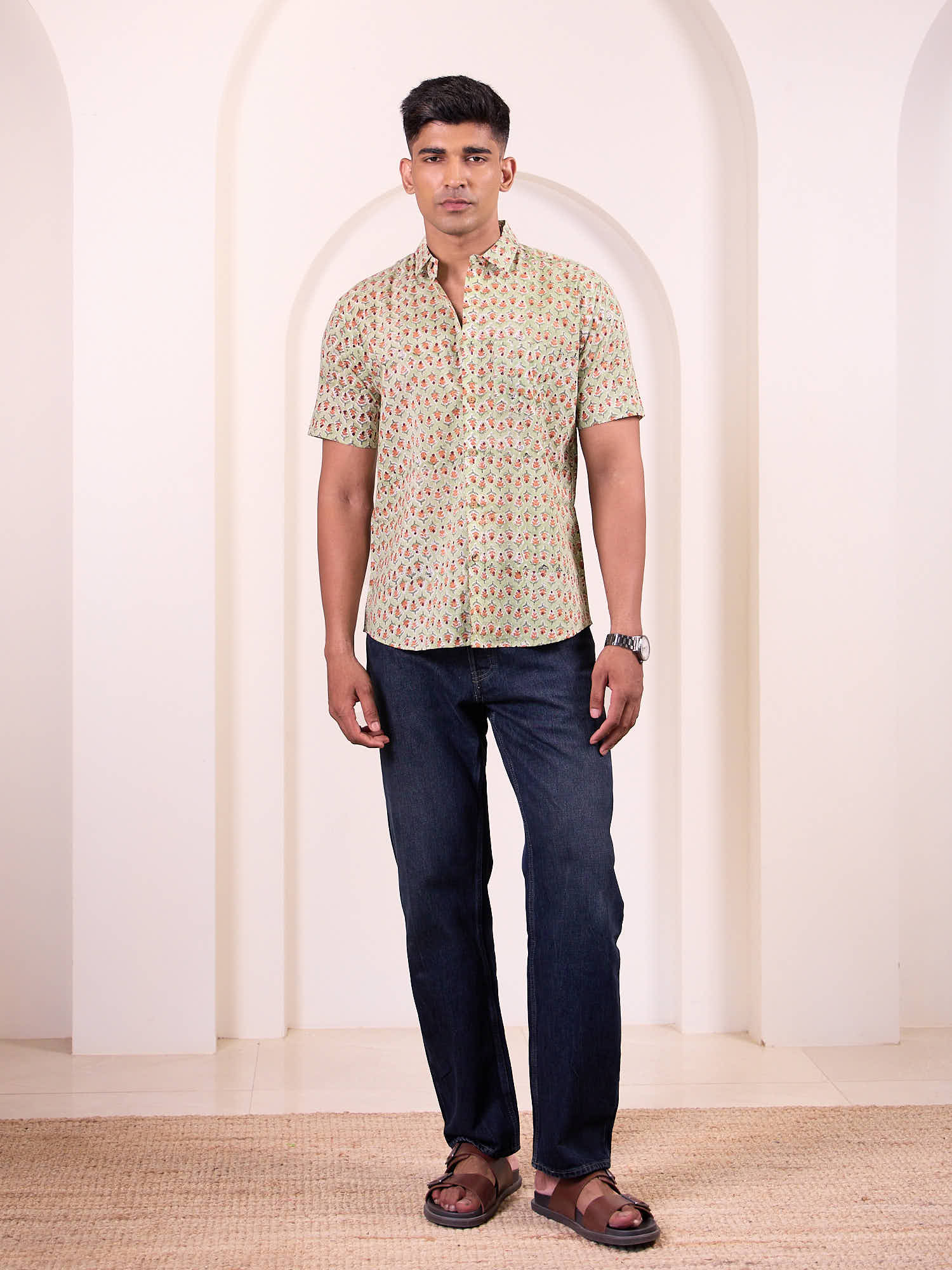 Men model wearing short sleeve floral printed shirt with blue jeans
