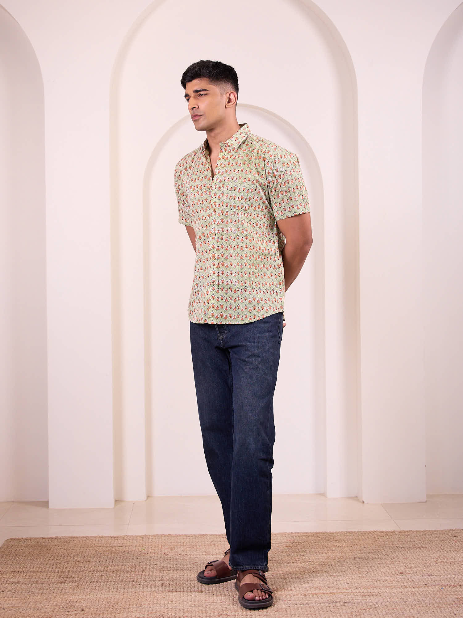 Men model wearing short sleeve floral printed shirt with blue jeans