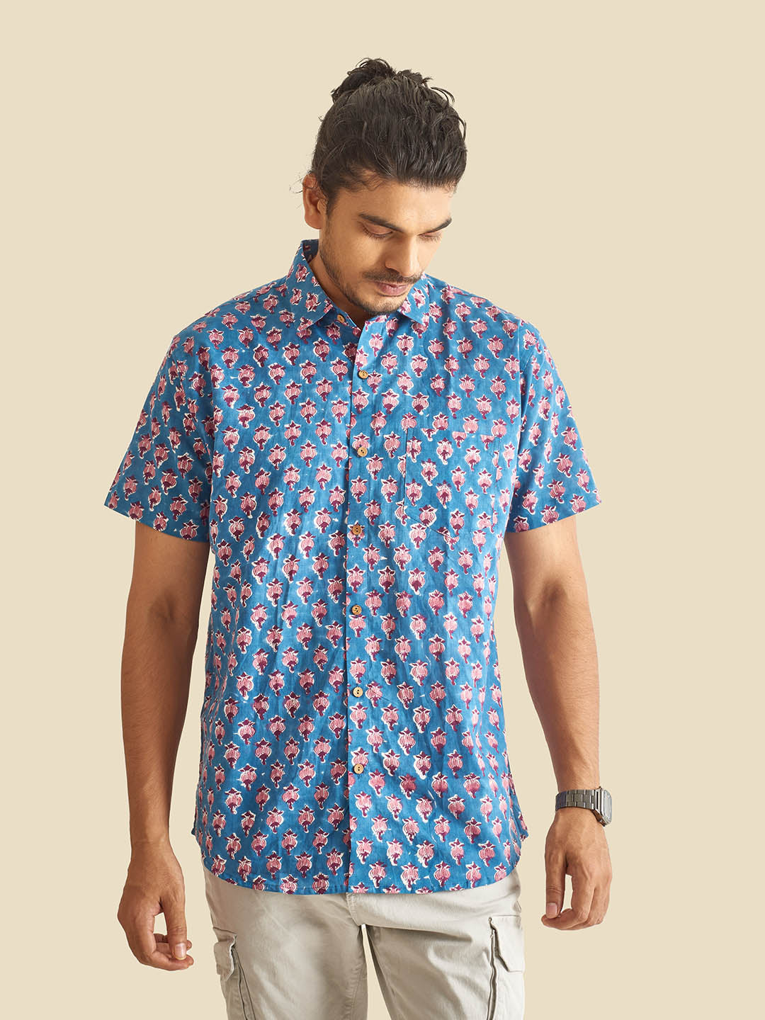 Model Facing sideways wearing Blue Floral Block Printed Halfsleeves Cotton Shirt by Brand Patrah