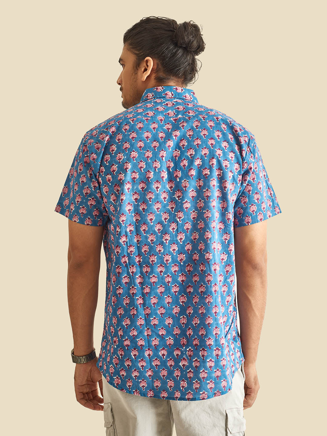 Model facing backwards wearing Blue Floral Block Printed Halfsleeves Cotton Shirt by Brand Patrah