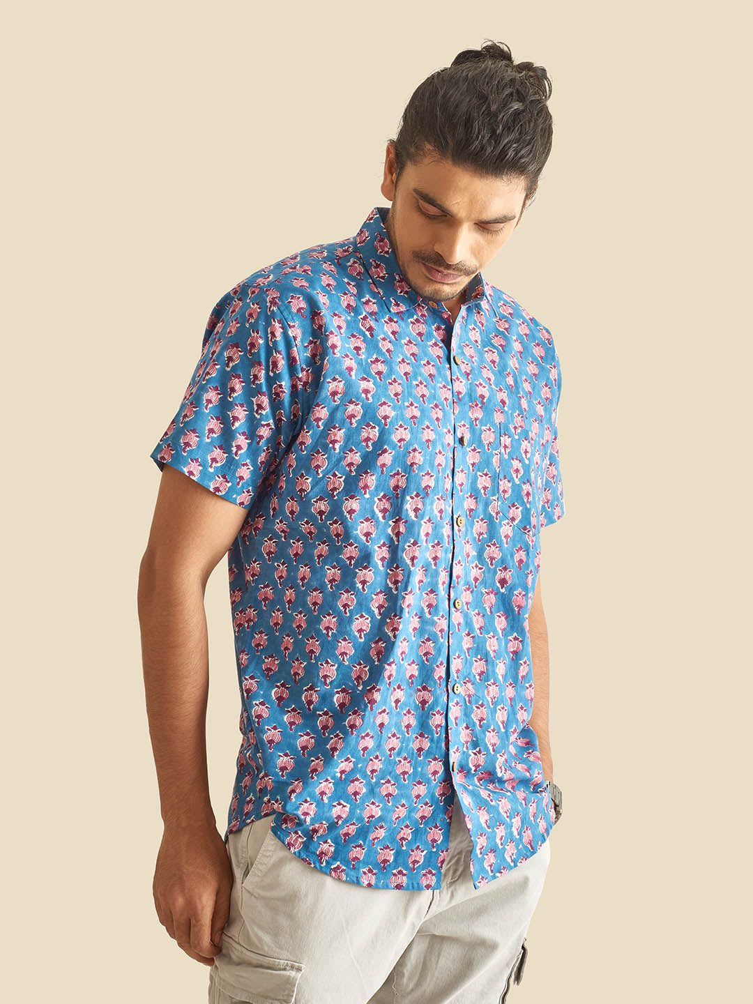 Model Facing sideways wearing Blue Floral Block Printed Halfsleeves Cotton Shirt by Brand Patrah