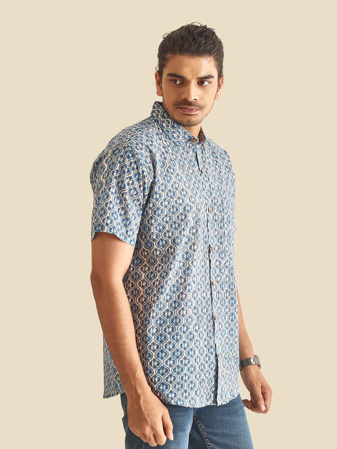 Model Facing sideways wearing Blue and White Ethnic Block Printed Holiday Halfsleeves Cotton Shirt by Brand Patrah