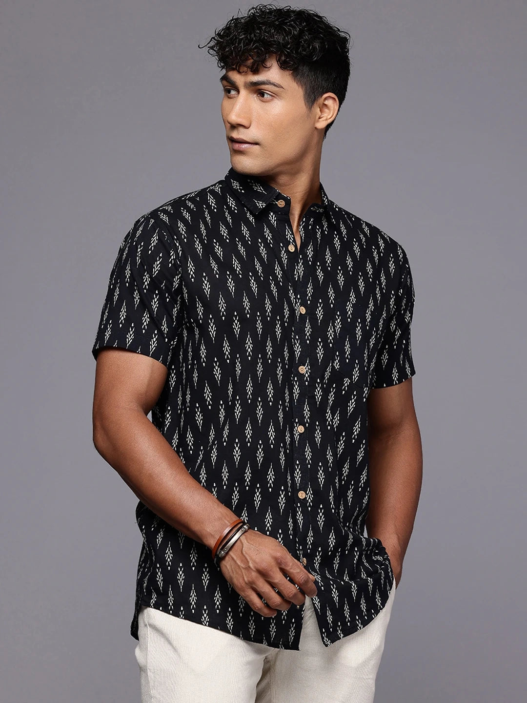 Side profile of man wearing black ikkat cotton shirt for casual outings