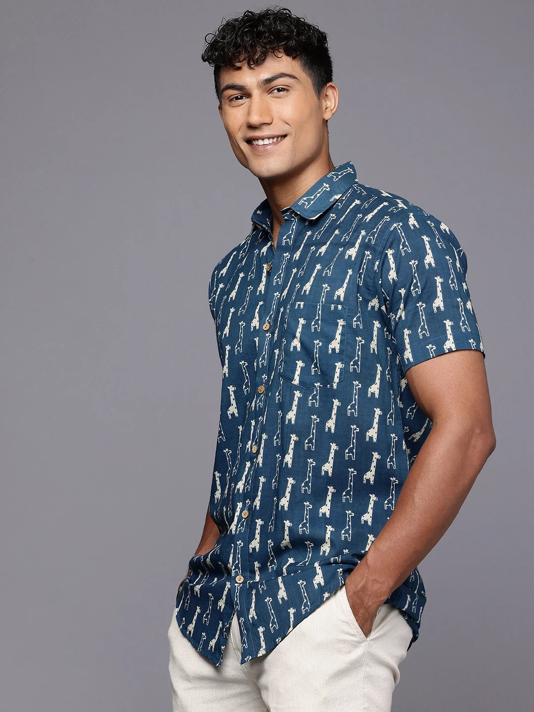 Side profile of man wearing blue giraffe print cotton shirt