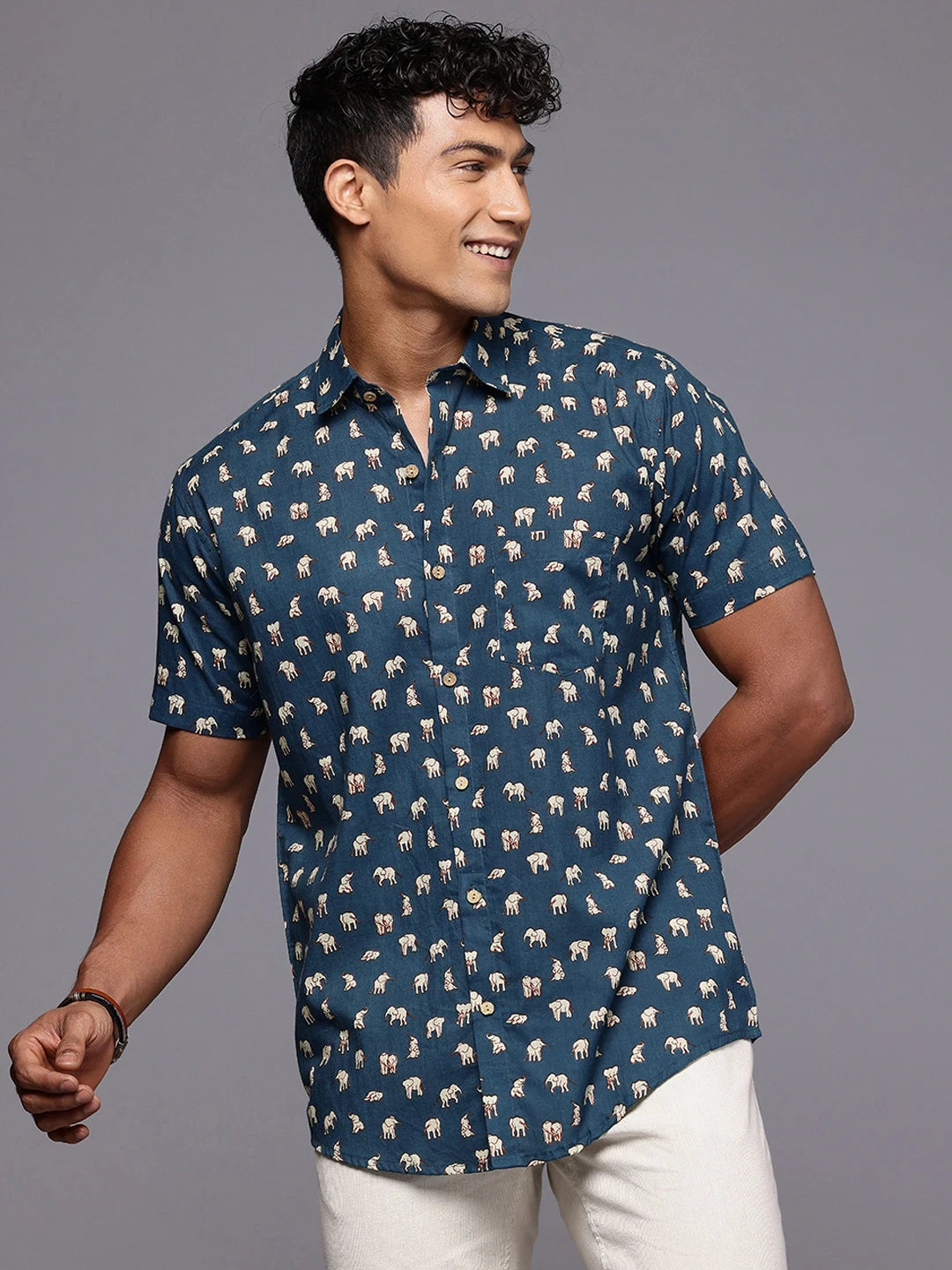 Side profile of man wearing elephant print shirt for casual outings