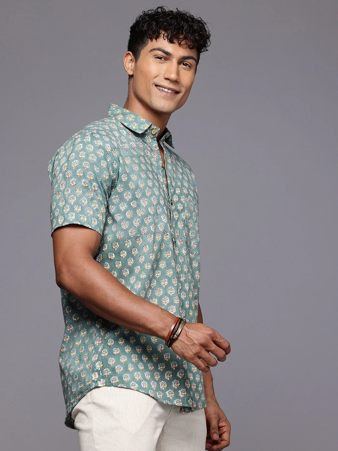 Side profile of man wearing olive green floral print cotton shirt