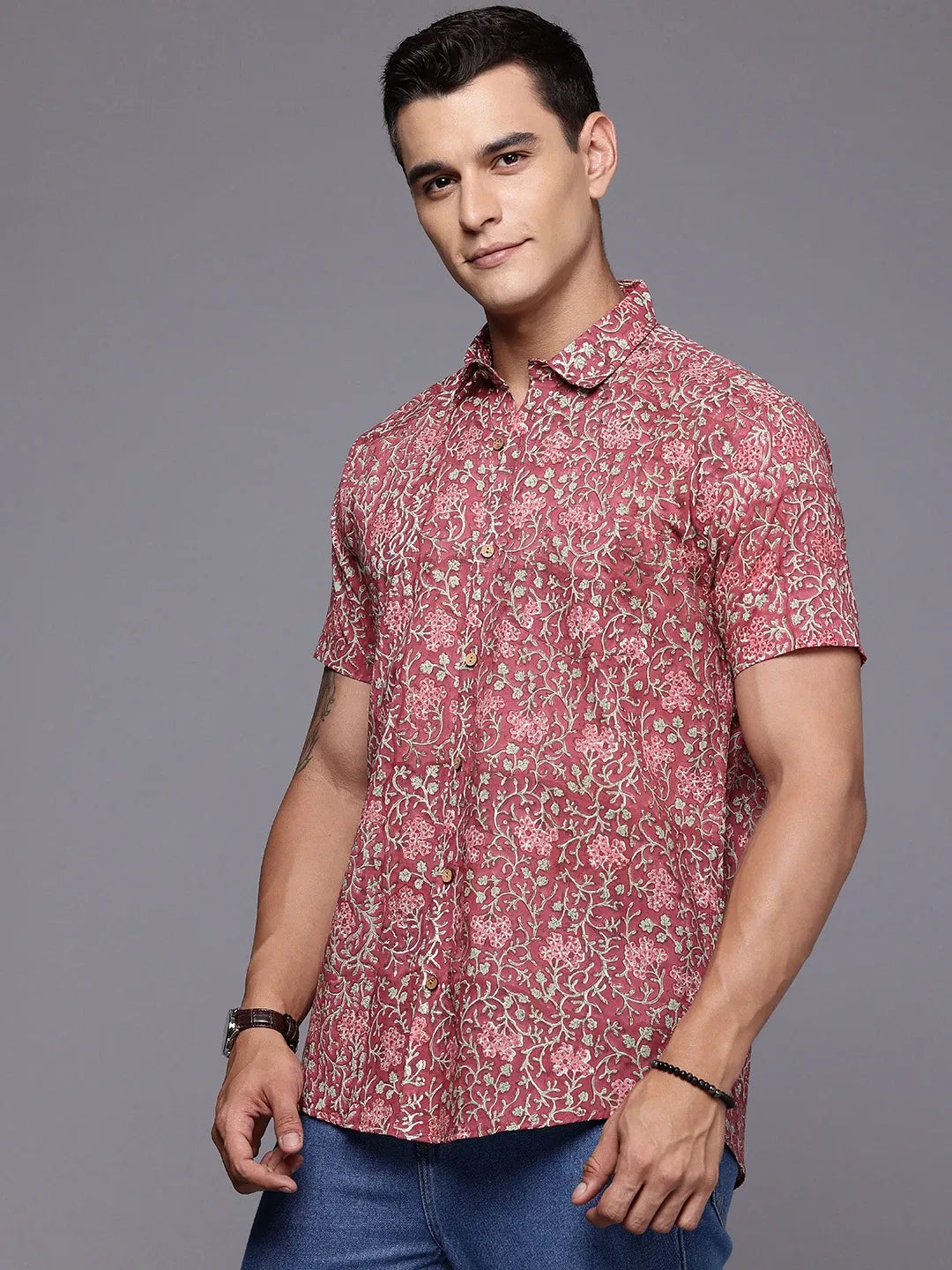 Side profile of rouge floral shirt worn by man for casual summer look