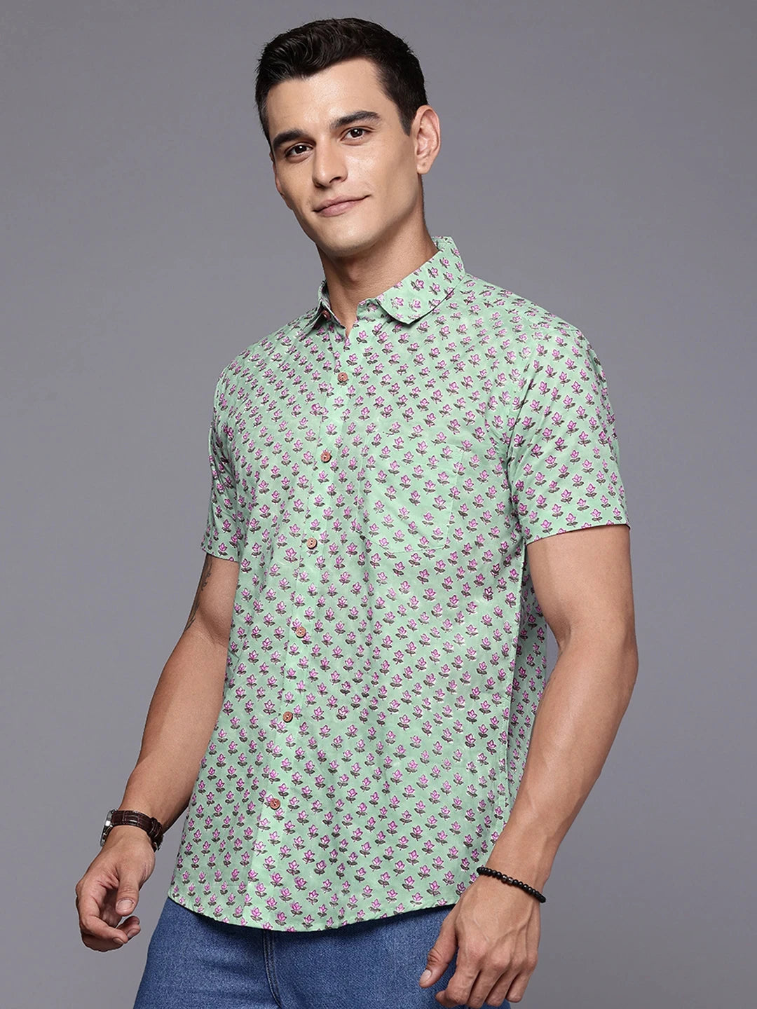Side profile of sage floral shirt on model styled for casual wear