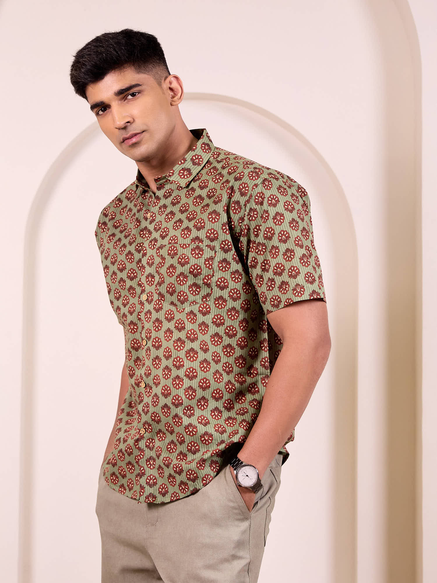 Model wearing a ethnic printed shirt standing against a neutral background