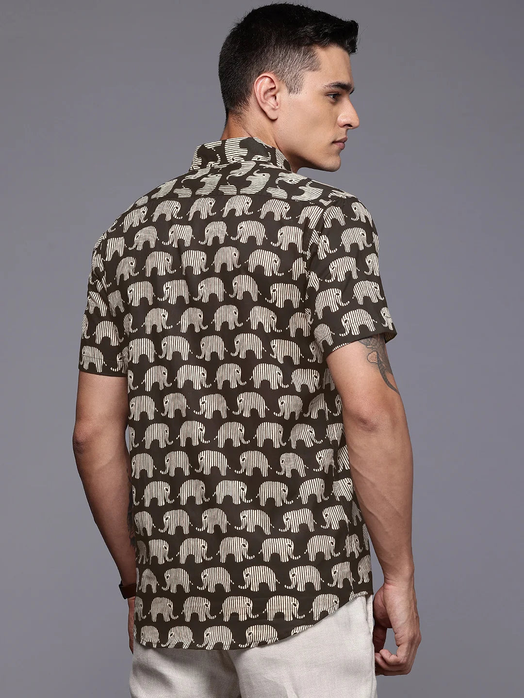 Man wearing elephant print short sleeve shirt