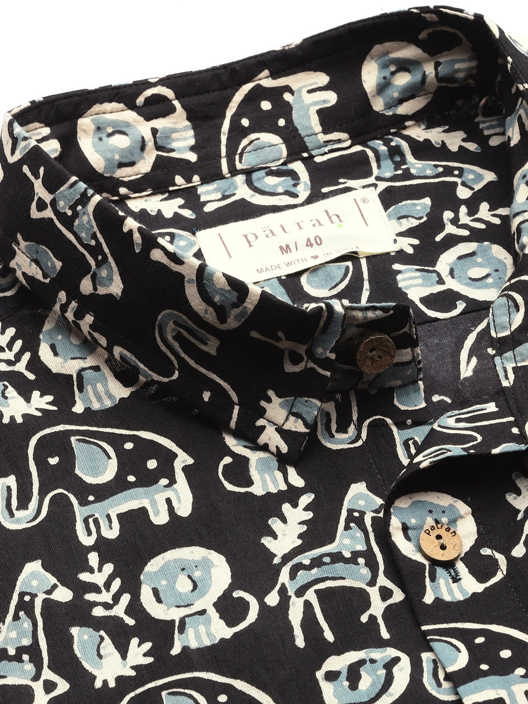 Black shirt with white and blue animal pattern, featuring a patrah label.