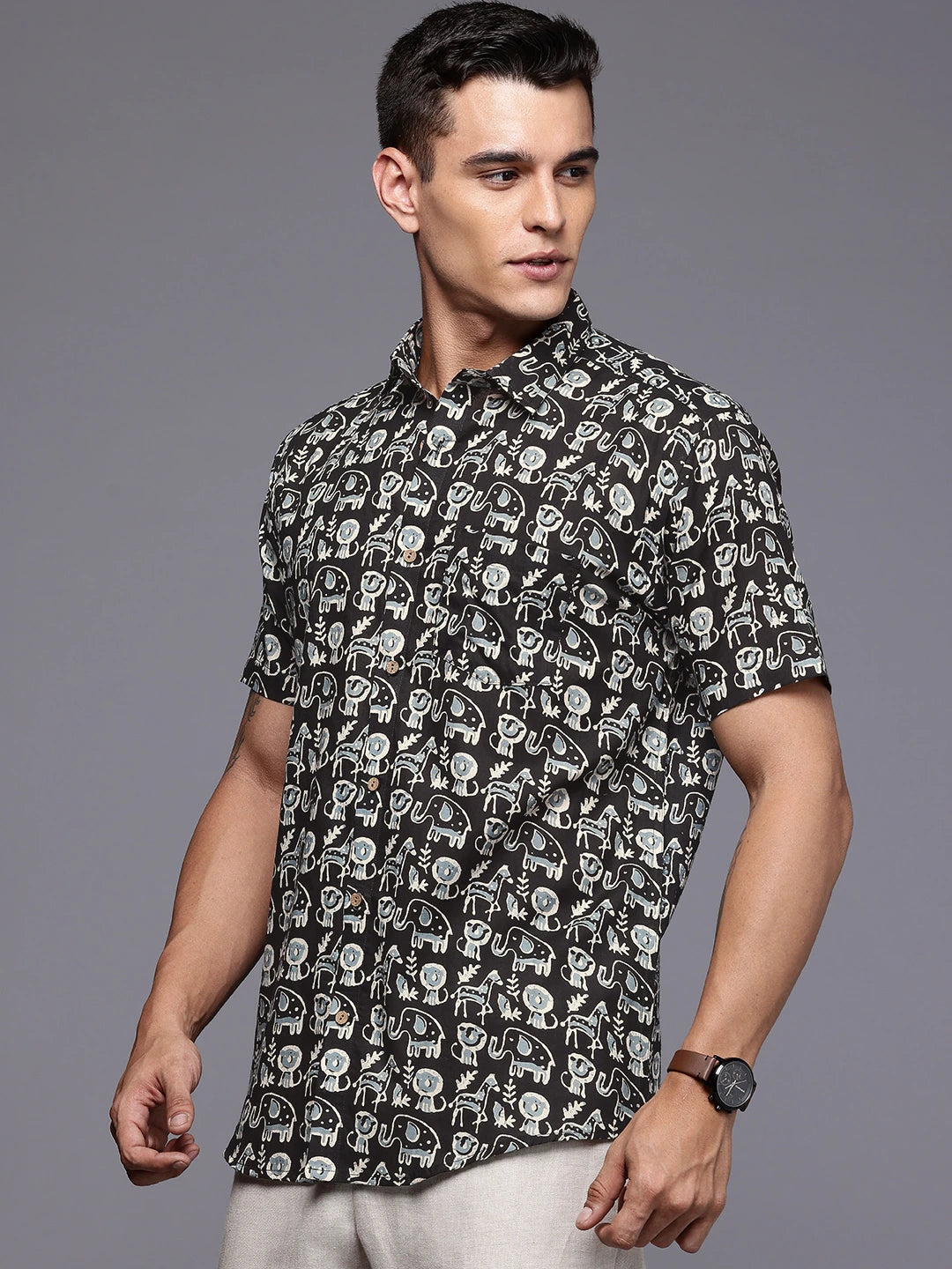 Man wearing a black printed short sleeves shirt