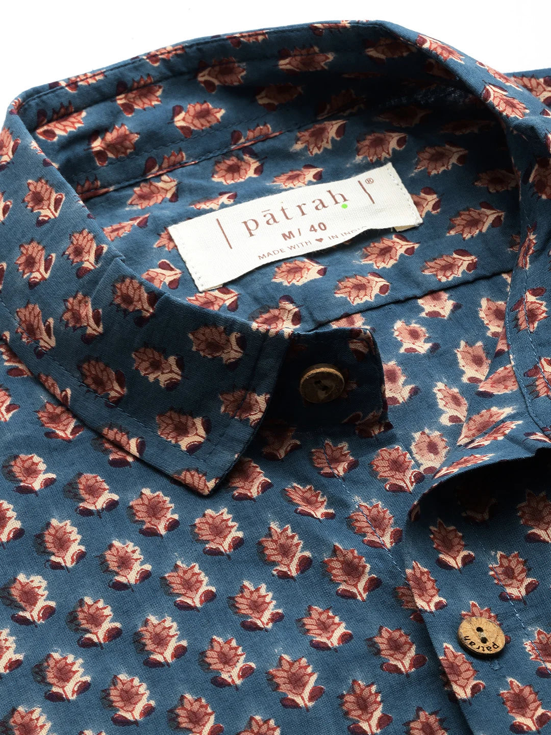 Blue shirt with red floral pattern and Patrah label