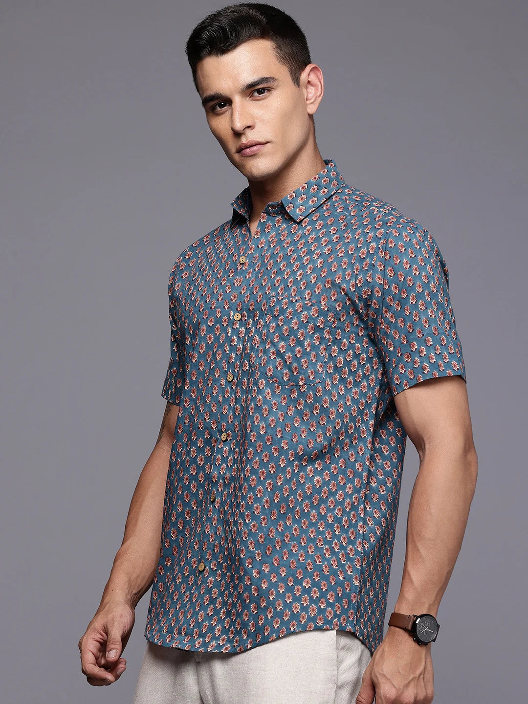 Short sleeve blue cotton shirt with floral print