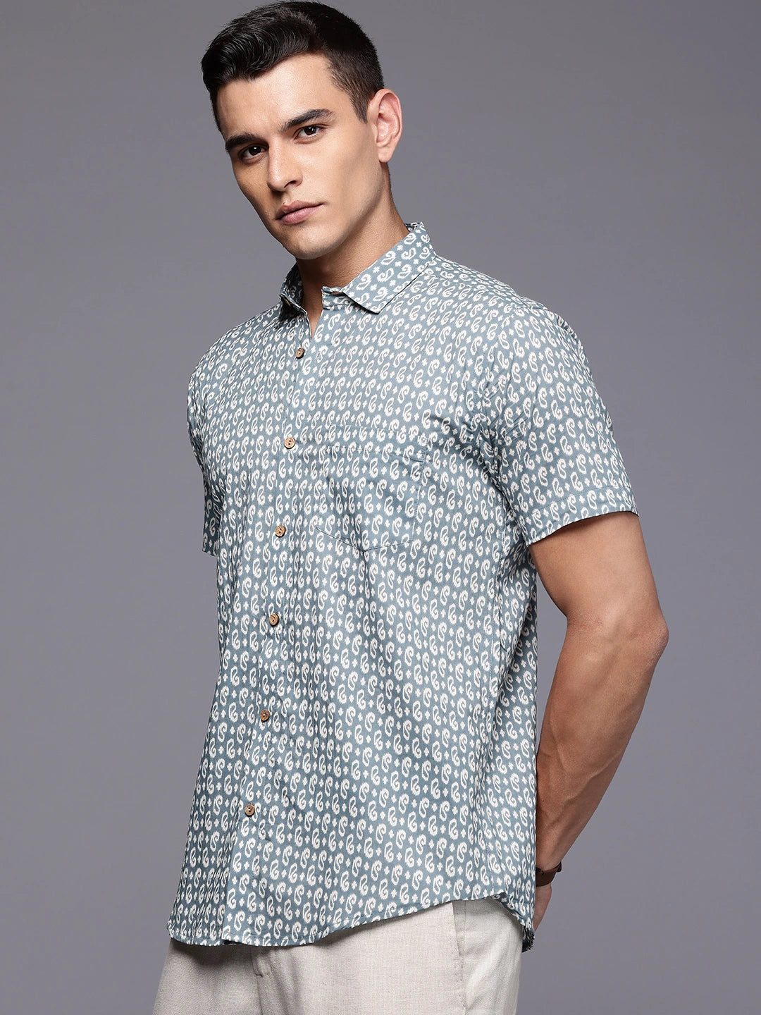 Man wearing a blue printed short-sleeve shirt.