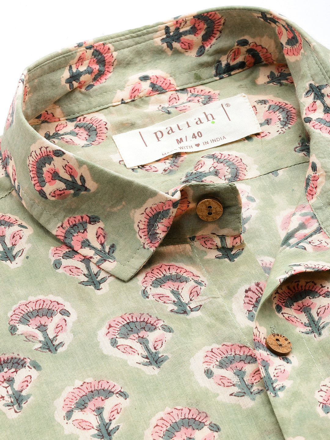 Green shirt with floral pattern and patrah label