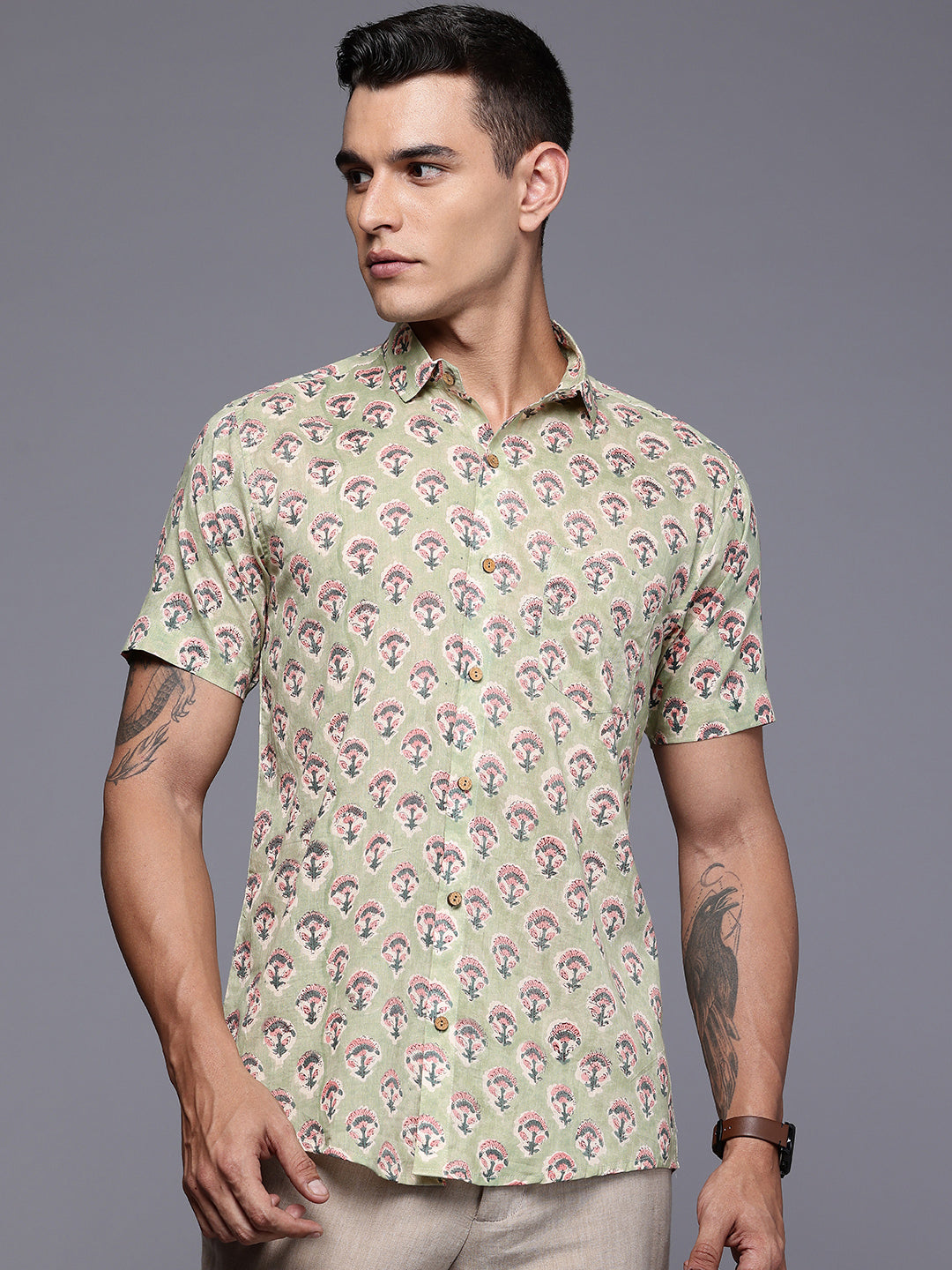 Man wearing a green floral shirt with short sleeves
