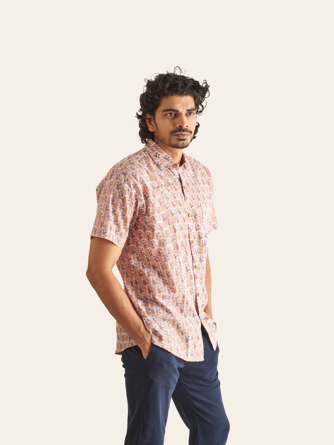 Model Facing sideways wearing Dusty Pink Floral Handblock Printed Cotton Shirt by Brand Patrah