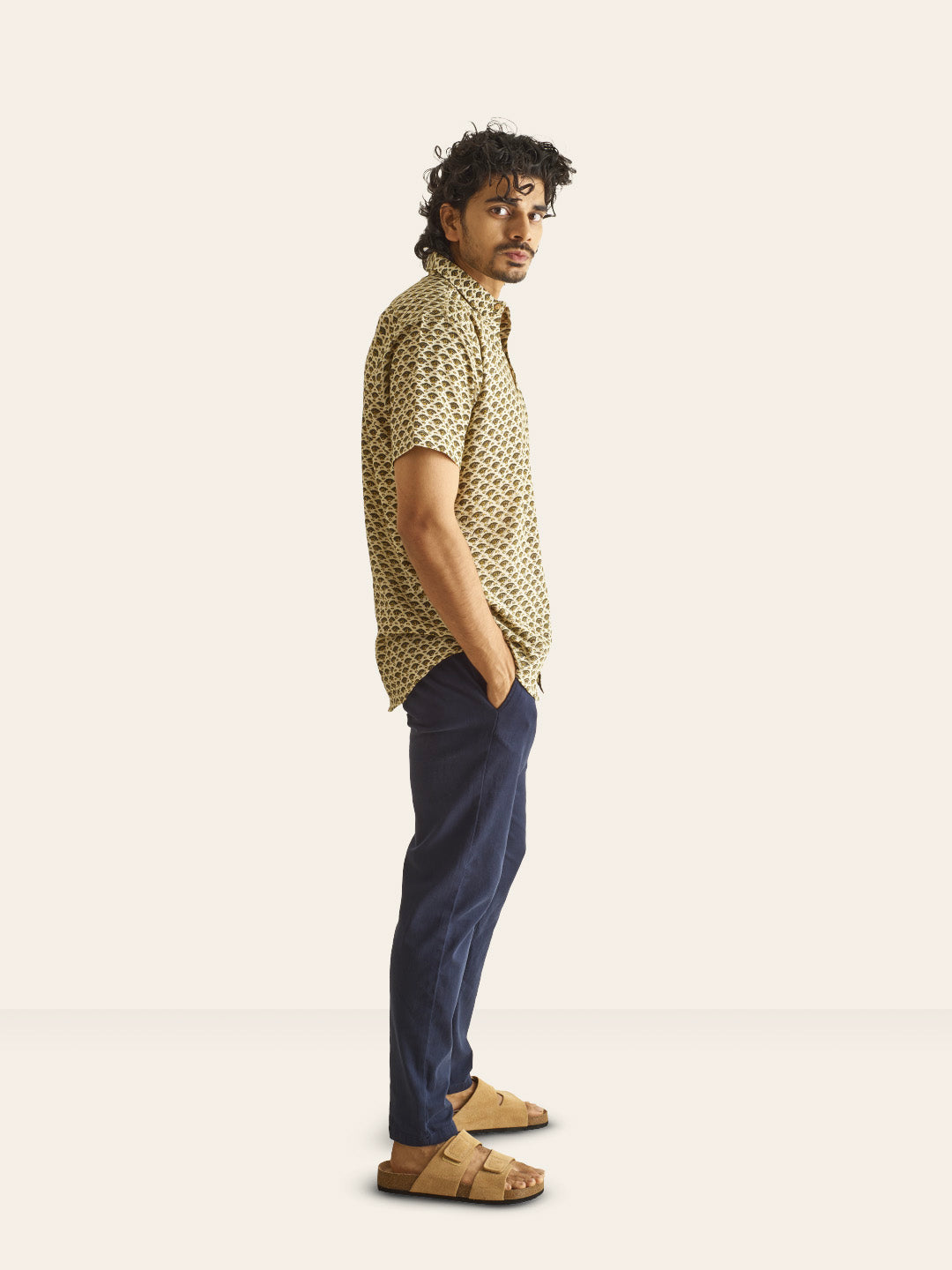 Model Facing sideways wearing Mustard Motif Ivory Handblock Printed Cotton Shirt by Brand Patrah