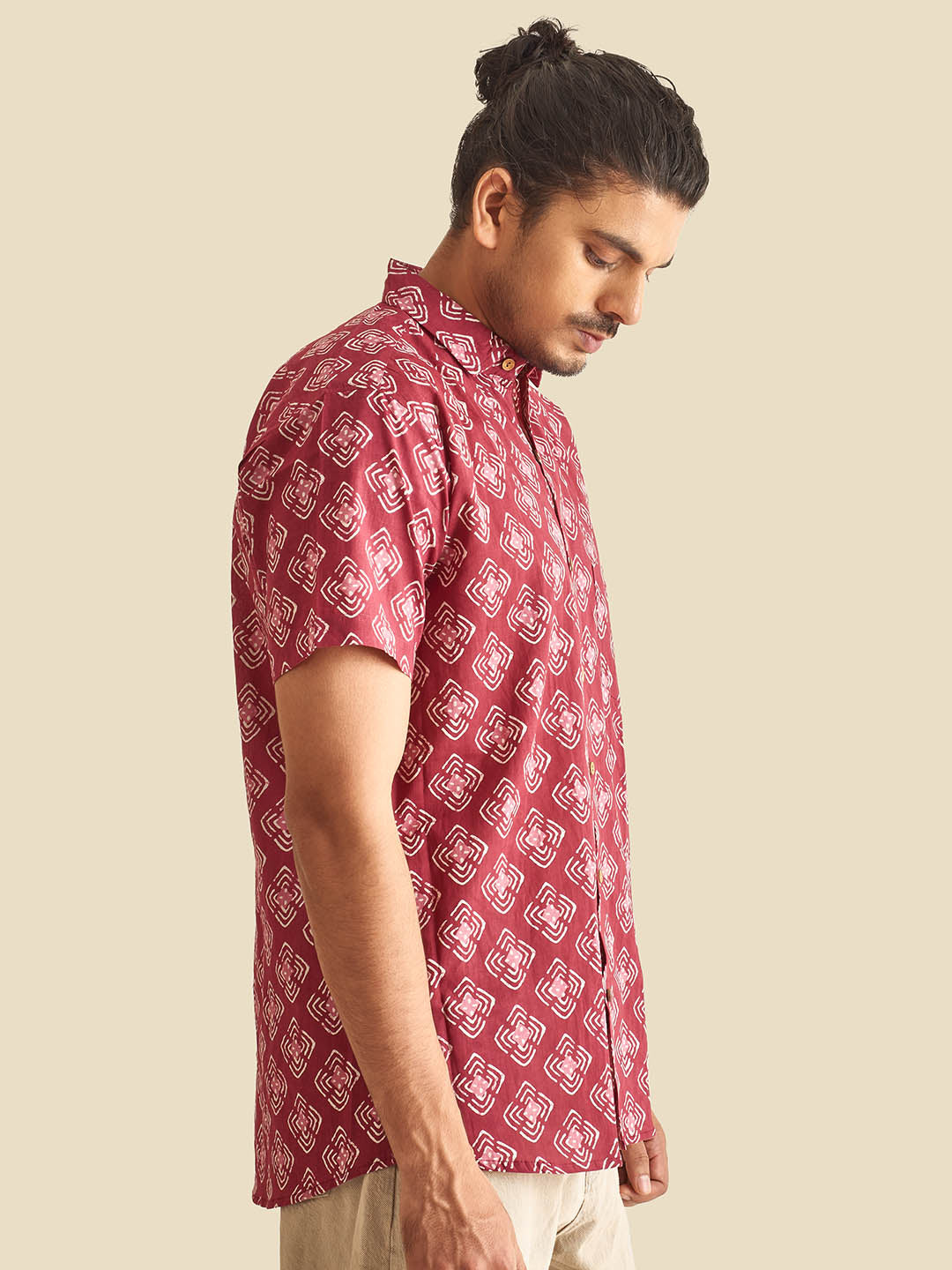 Model Facing sideways wearing Plum Abstract Chula Printed Halfsleeves Cotton Shirt by Brand Patrah