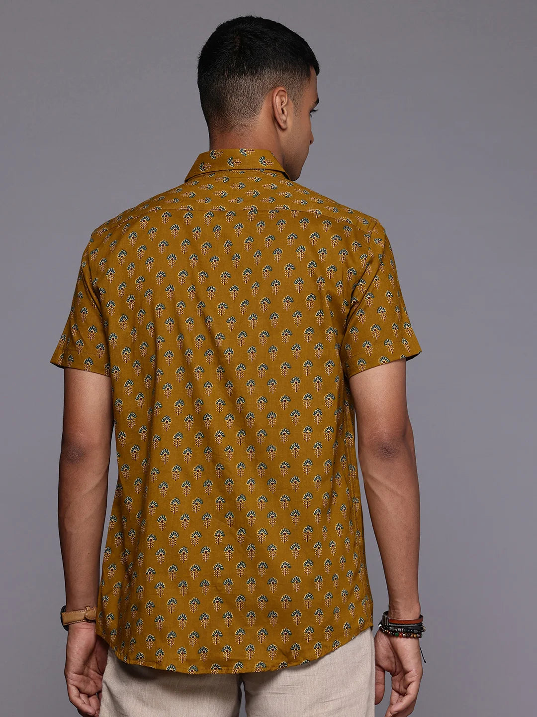 Model facing backwards wearing Yellow Floral Print Shirt by Brand Patrah
