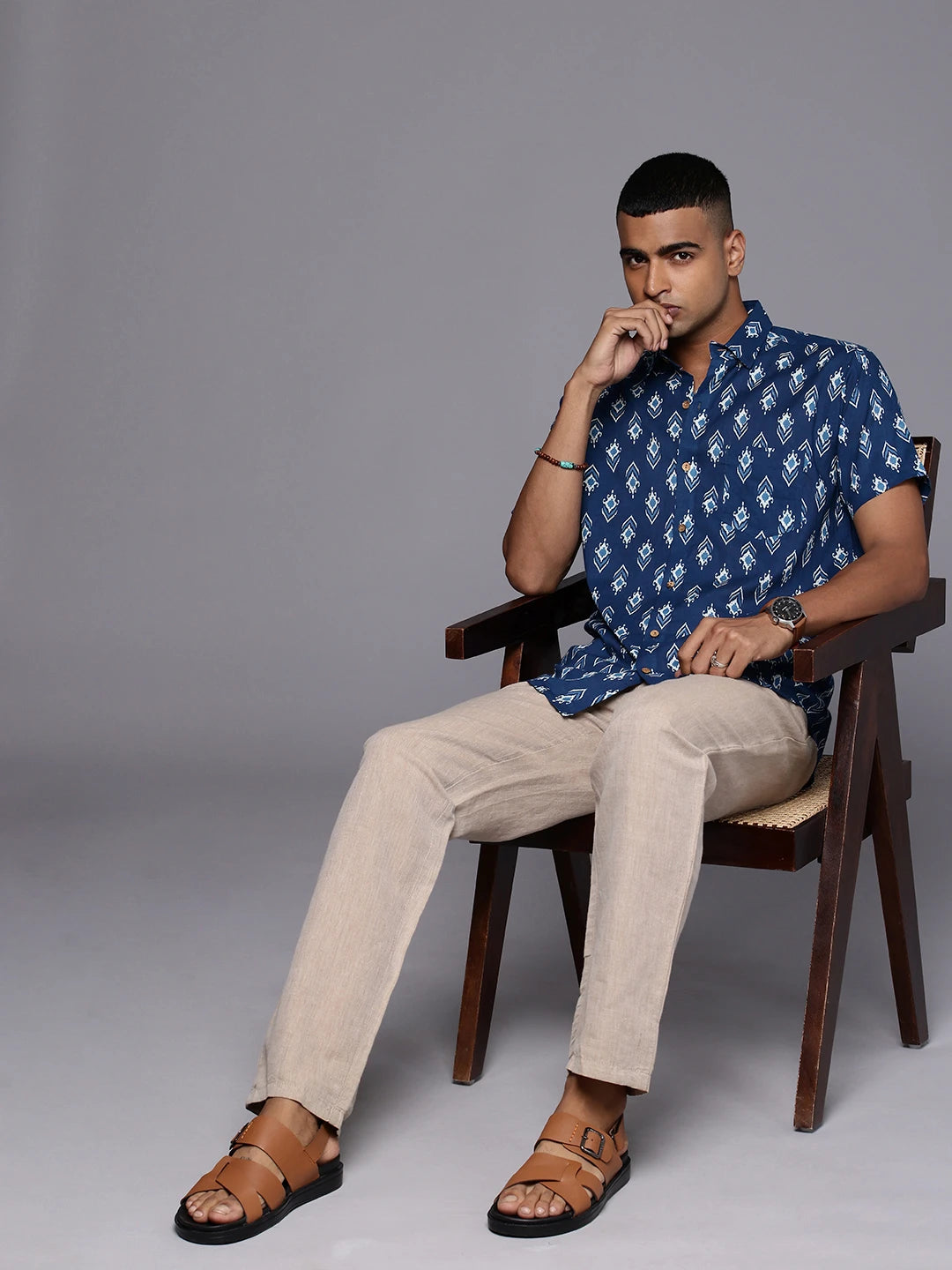 Model sitting on a chair wearing Blue Ikkat Cotton Shirt by Brand Patrah