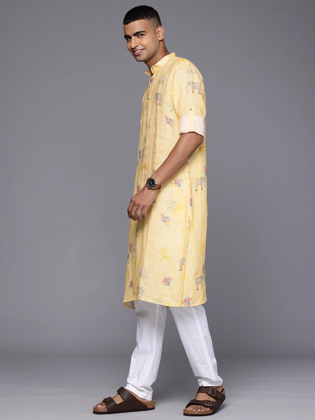 Model Looking sideways wearing Yellow Elephant Print linen Kurta by Brand Patrah