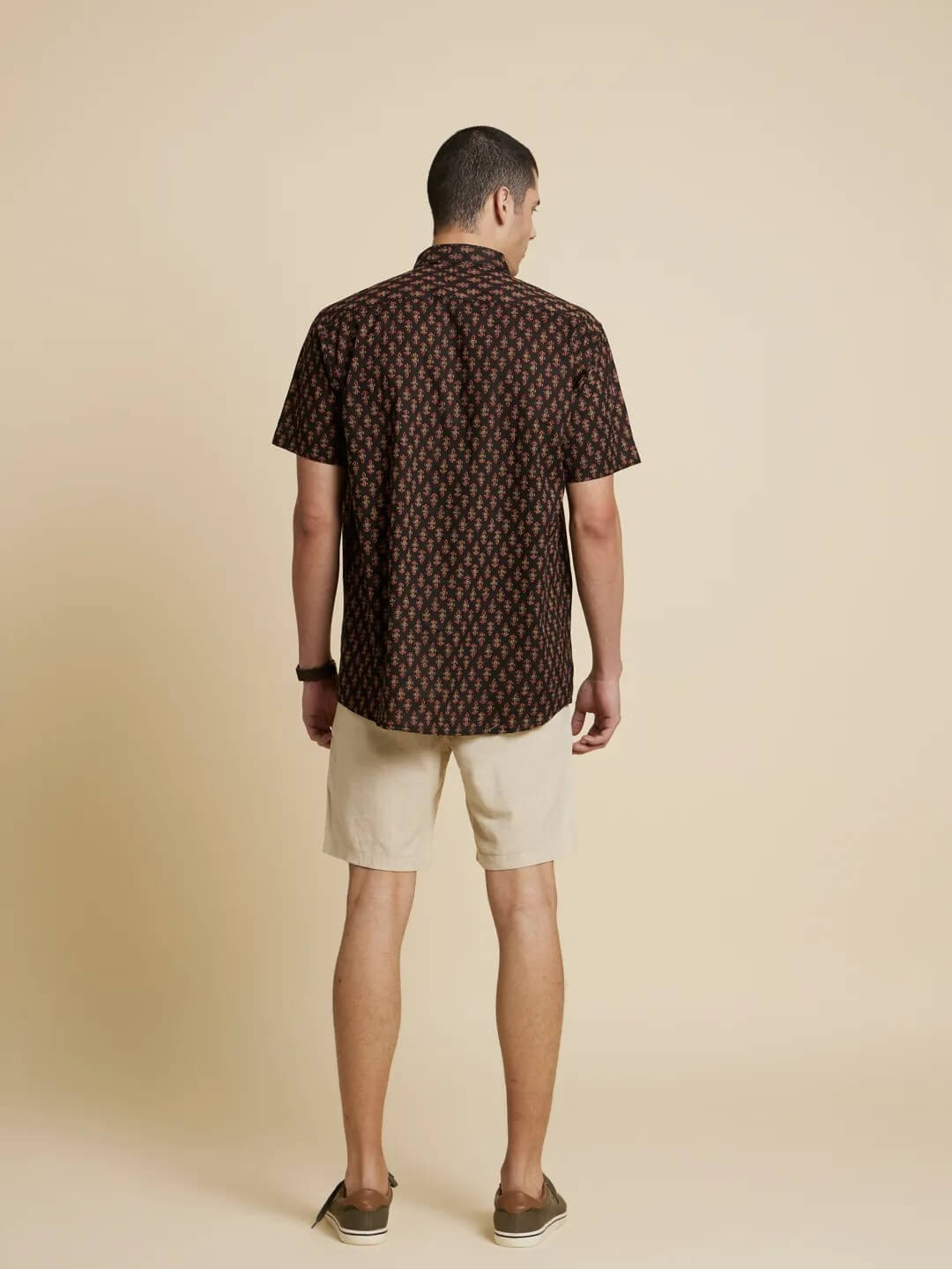 Model facing backwards wearing Boho Black Printed Shirt by Brand Patrah