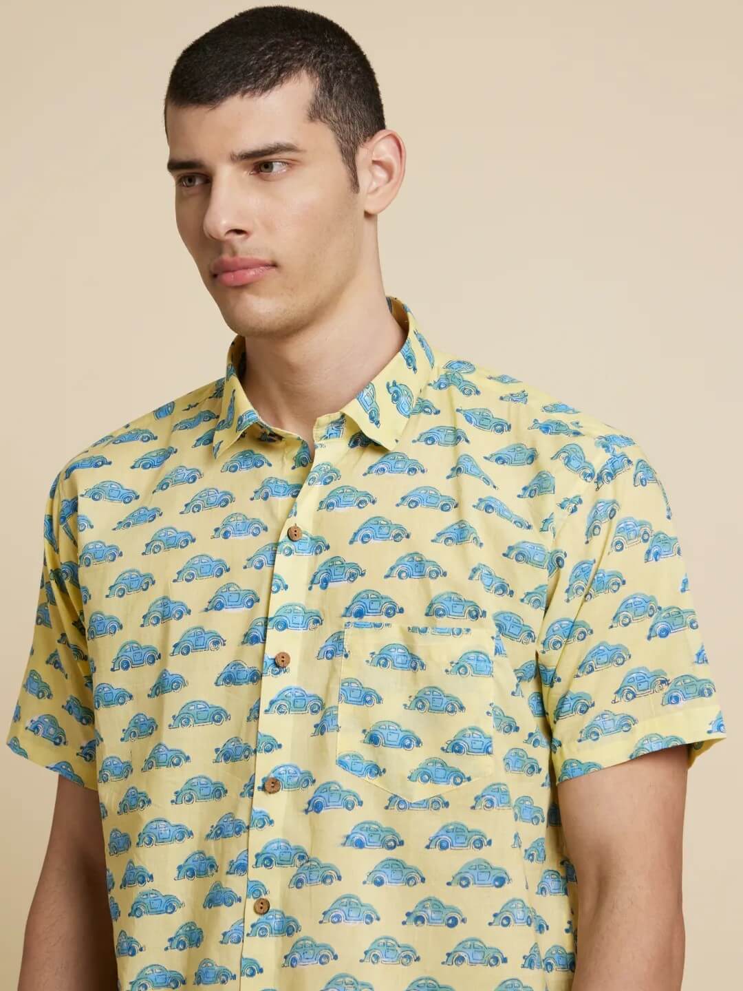 Model Facing sideways wearing Green and Blue Car Handblock Printed Shirt by Brand Patrah