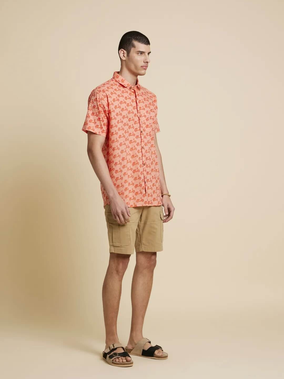 Model Facing sideways wearing Peach Orange Scooter Printed Shirt by Brand Patrah