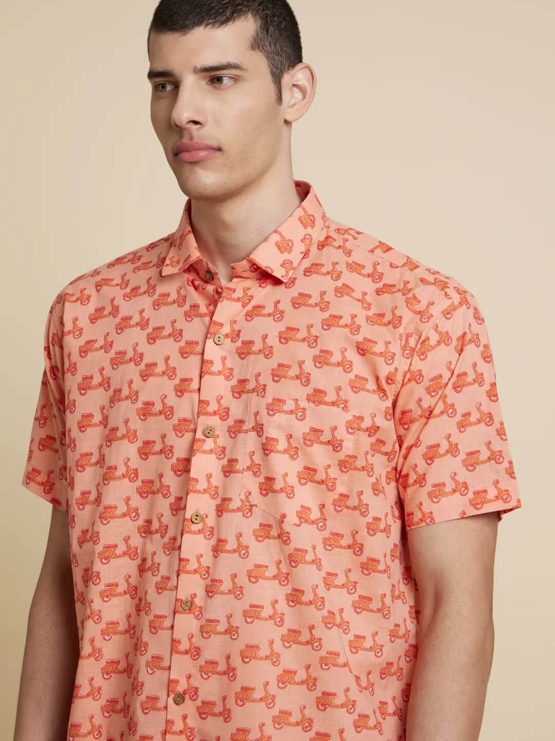 Model Facing sideways wearing Peach Orange Scooter Printed Shirt by Brand Patrah