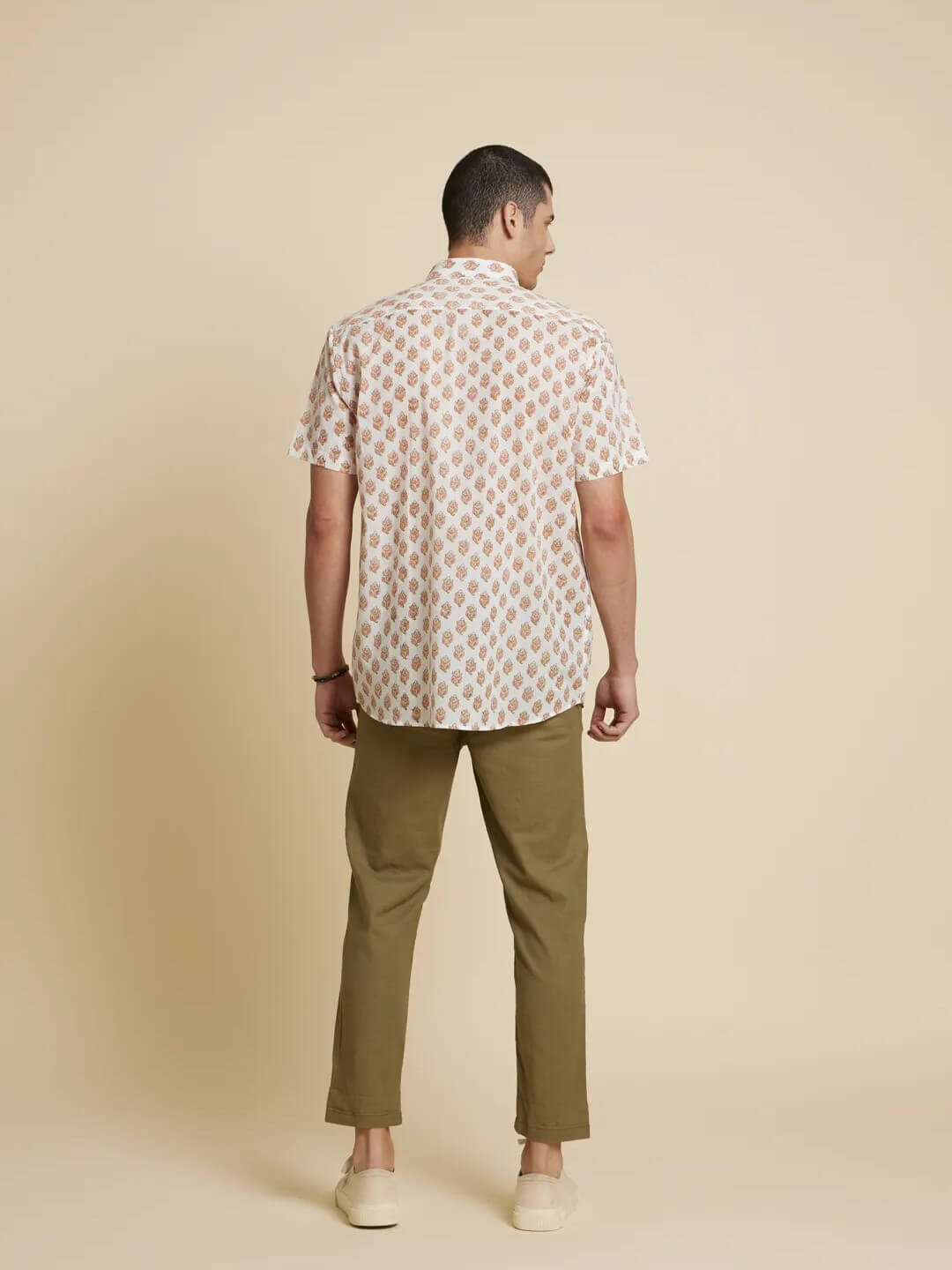 Model facing backwards wearing White Floral Handblock Printed Shirt by Brand Patrah