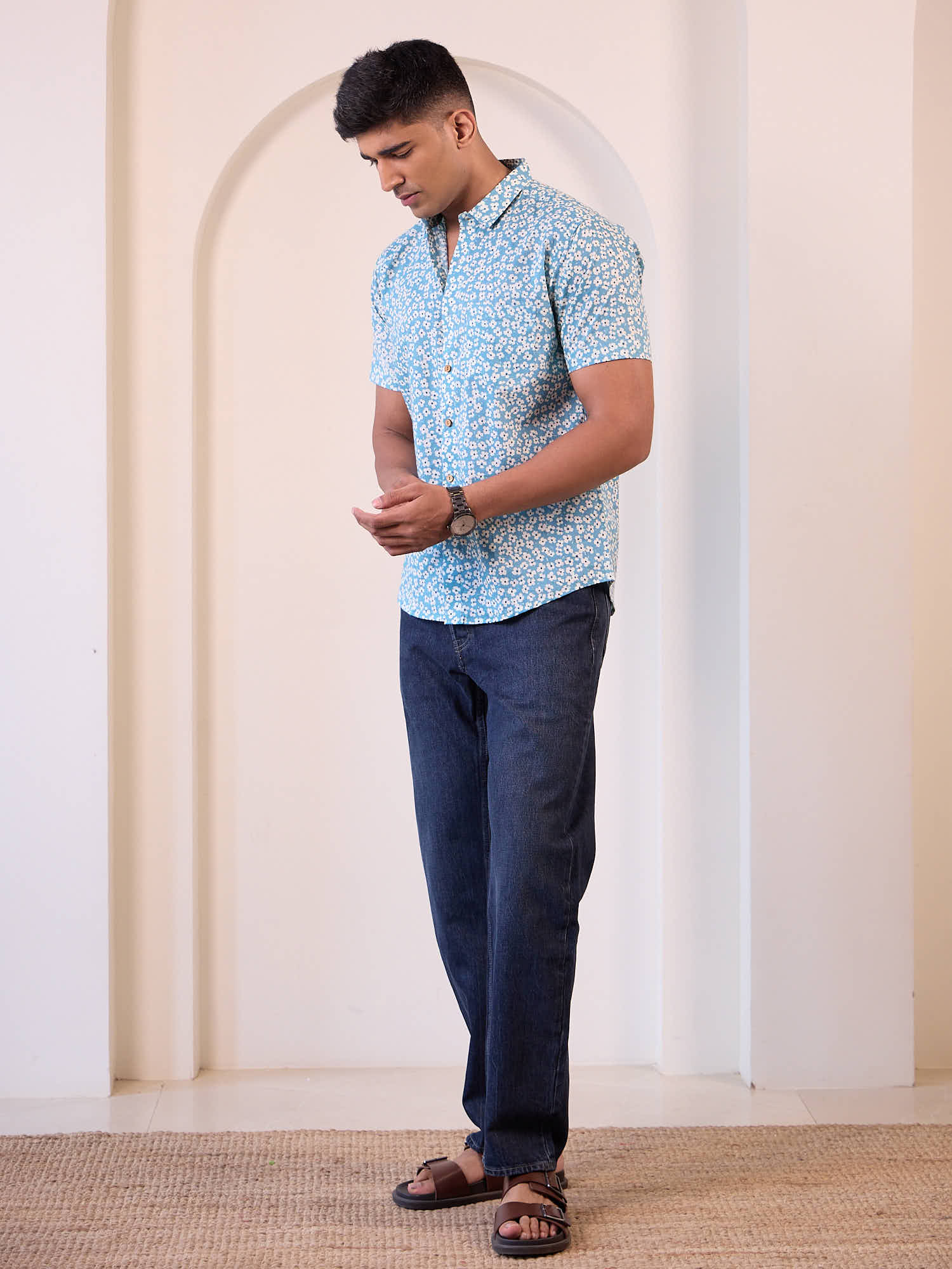 Men model wearing short sleeve floral printed shirt with blue jeans