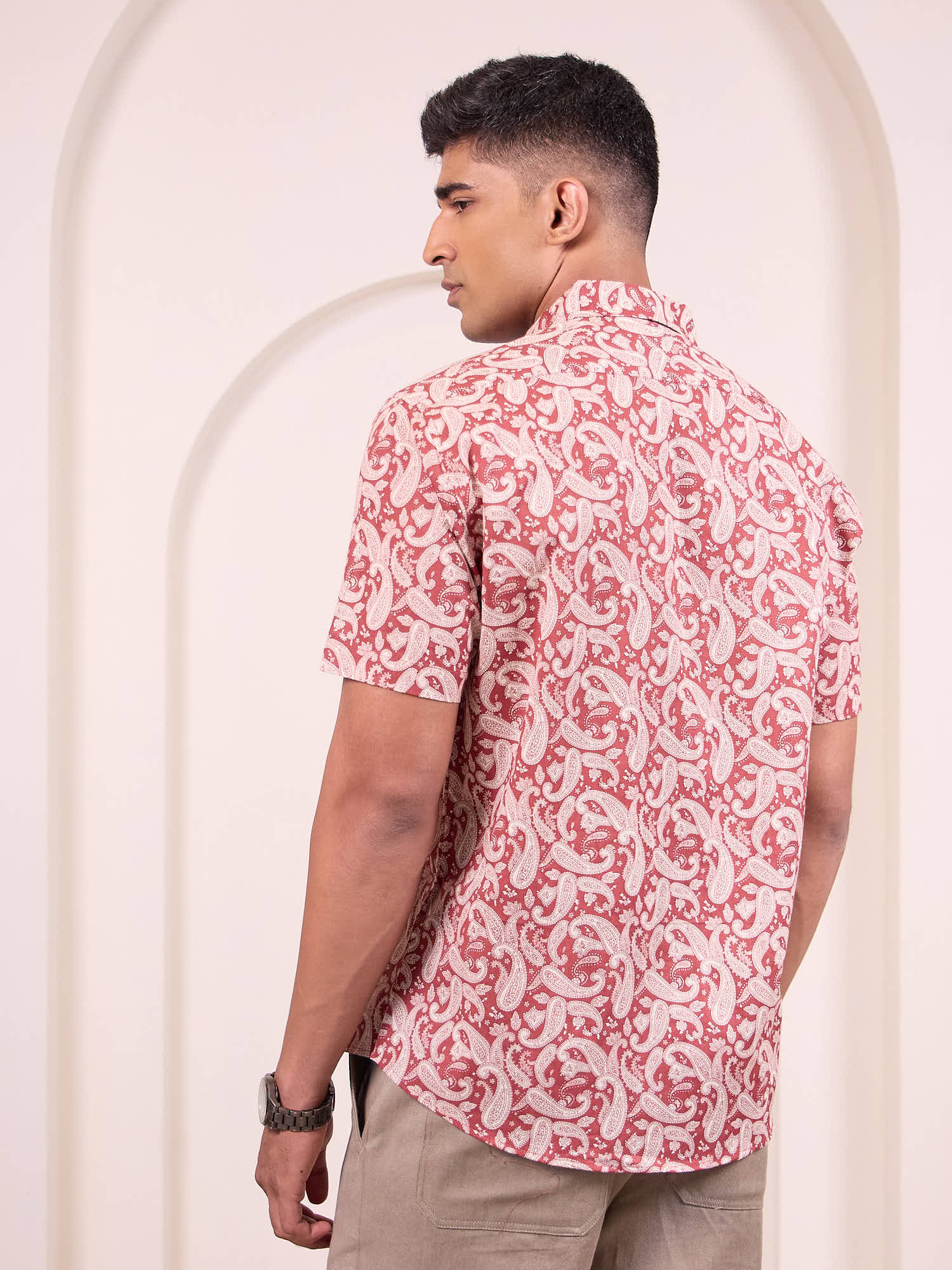 Model wearing printed short sleeve shirt back design